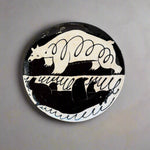 Decorative plate with bear design on a textured surface