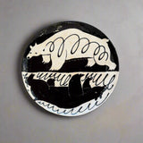 Decorative plate with bear design on a textured surface